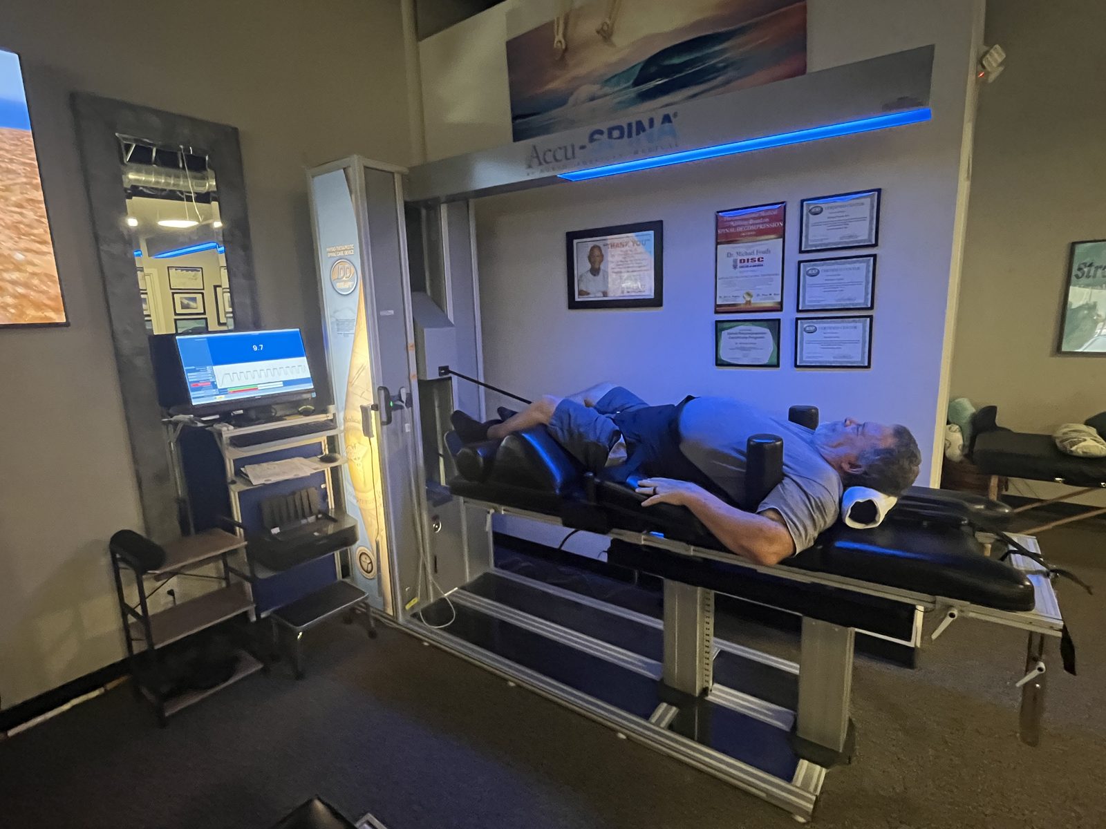 A patient mid-session on the AccuSpina table at Foudy Chiropractic, Mission Viejo